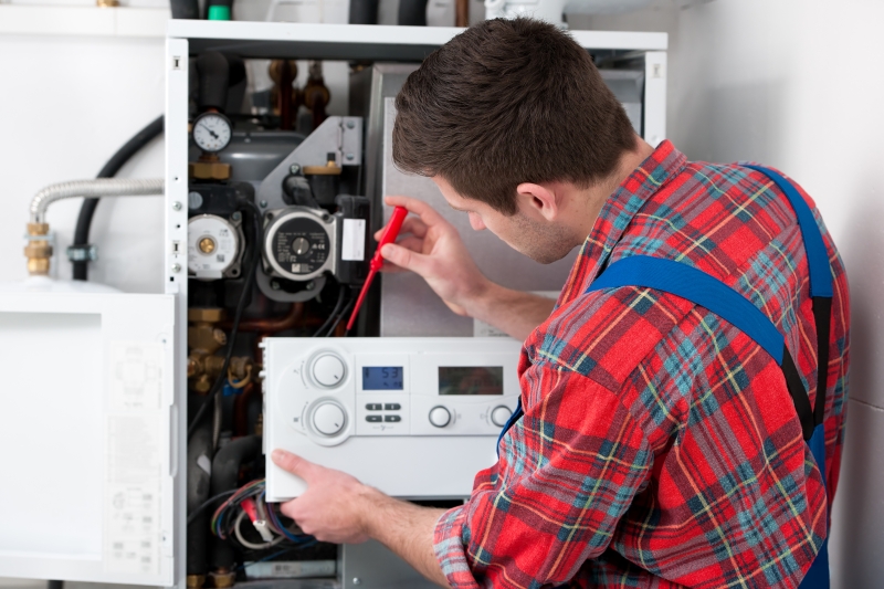 Gas Safe engineer working on a boiler in Acton